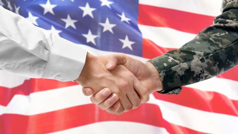 Civilian and Military Shaking Hands in front of US Flag